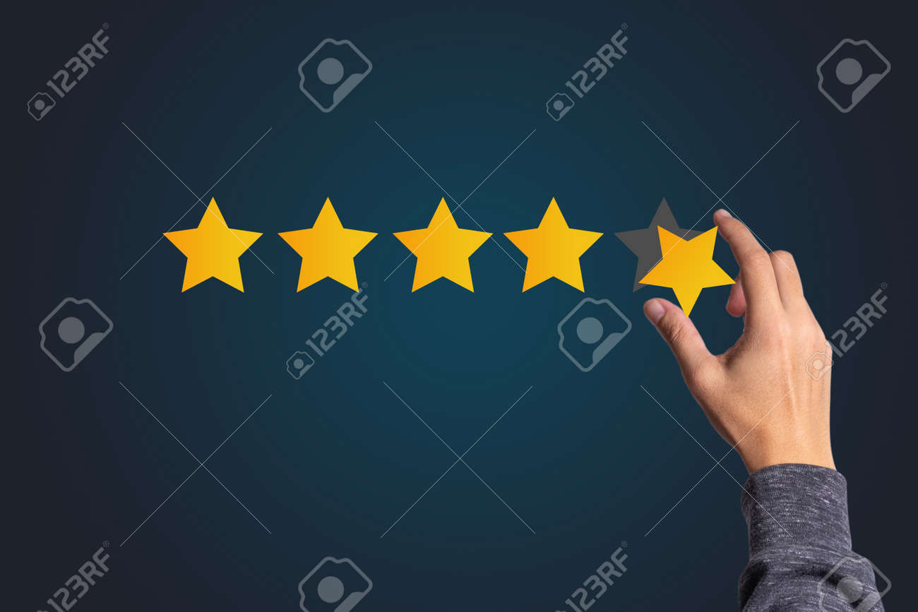 Customer satisfaction and product service evaluation concept , Hand holding and put yellow star to five stars with copy space. - 157950567 Customer satisfaction and product service evaluation concept , Hand holding and put yellow star to five stars with copy space. - 157950567