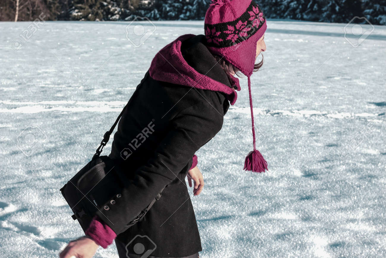 young man in warm clothing having a good time with snow in the winter - 87799072 young man in warm clothing having a good time with snow in the winter - 87799072