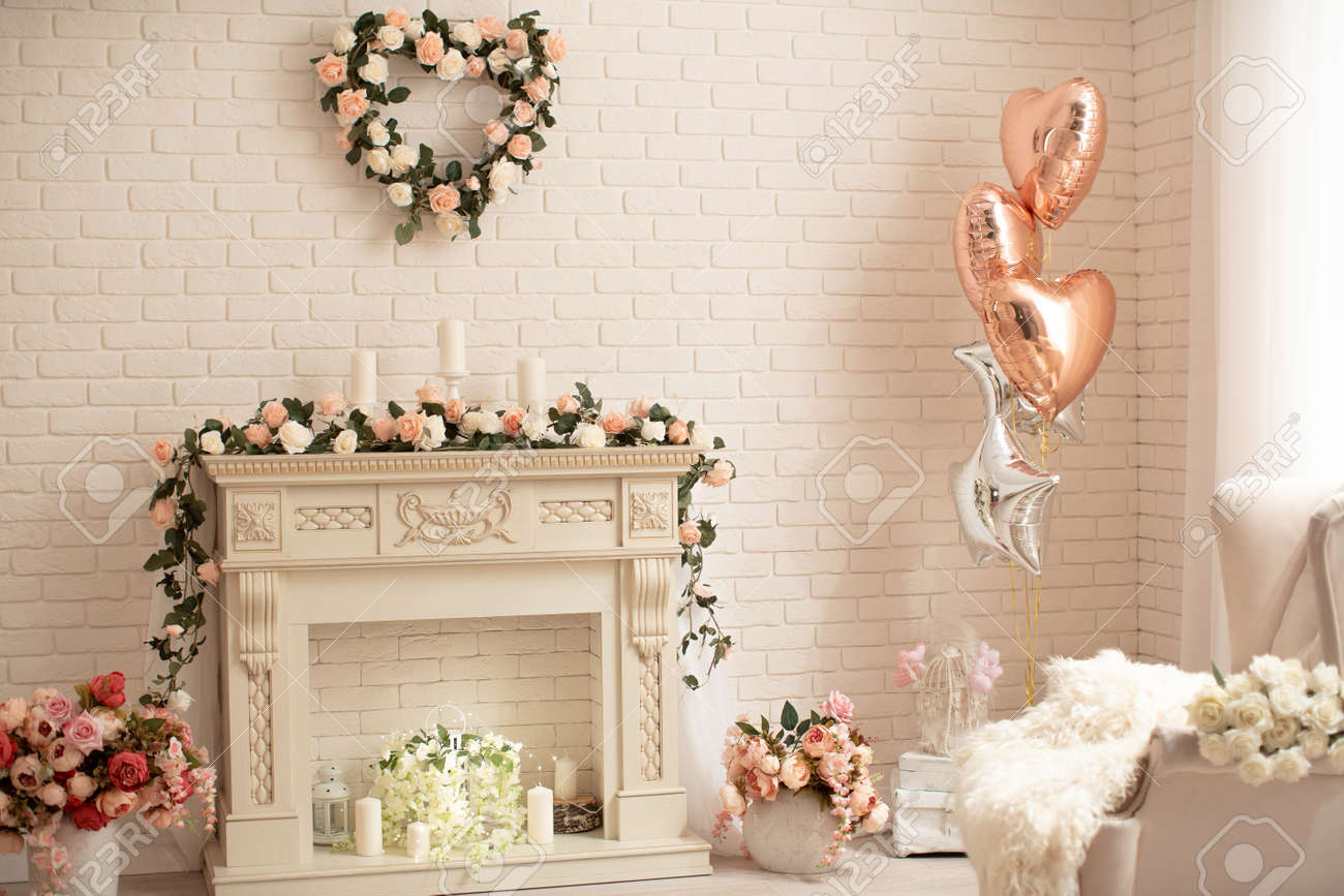 Decoration Of The Fireplace With Flowers In A Bright Interior