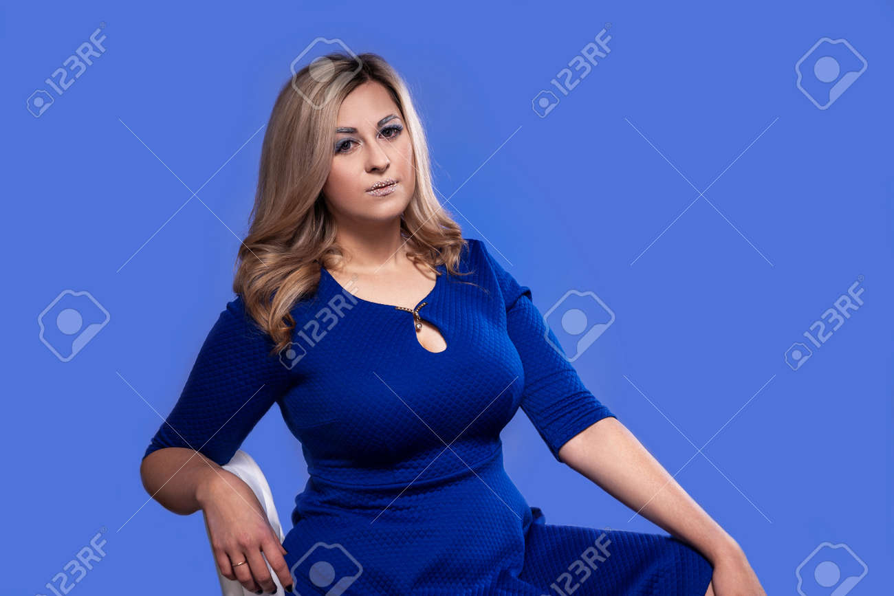 Curvy Blonde Model With Huge Breasts In Studio On Blue Background Stock  Photo, Picture and Royalty Free Image. Image 121352959.