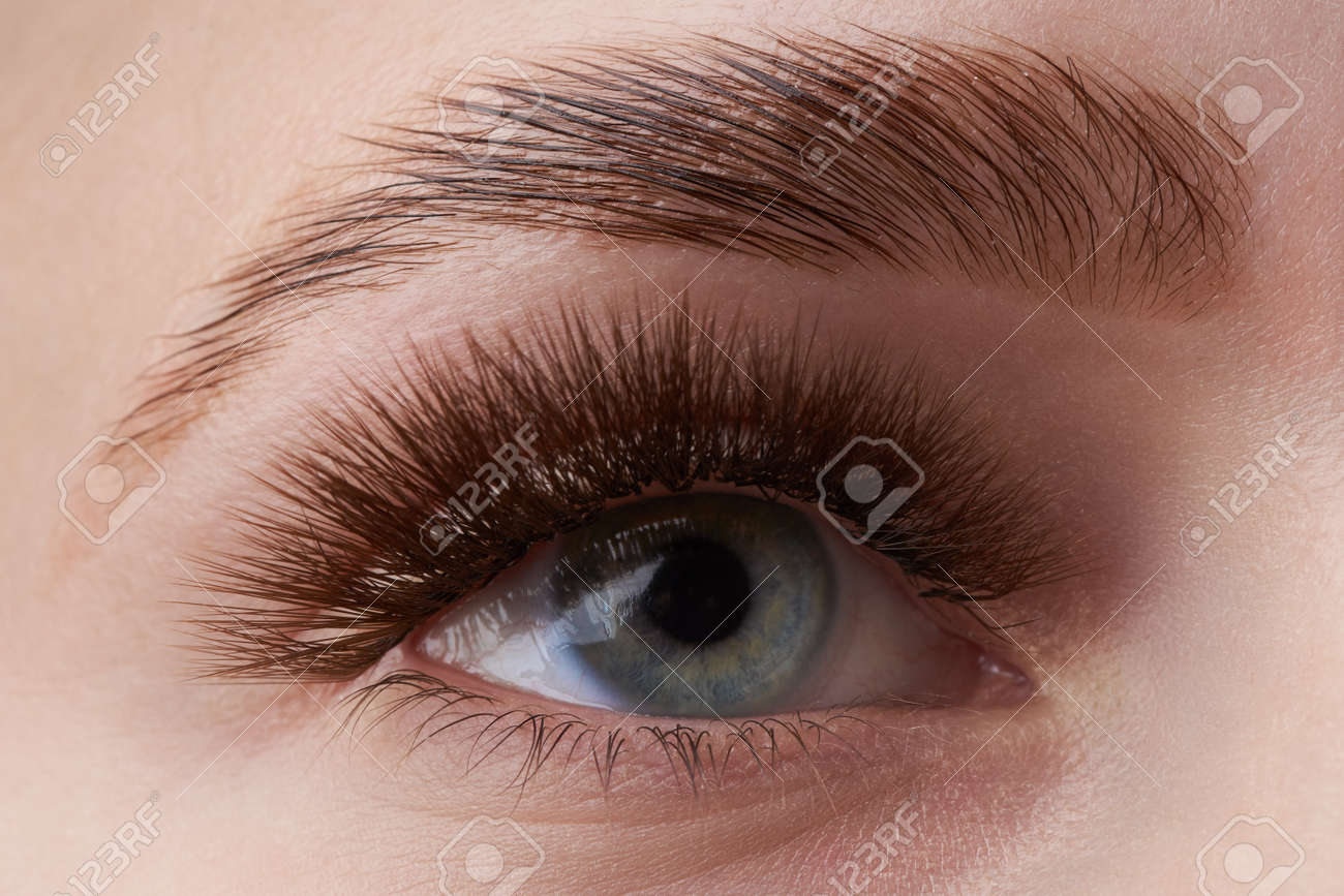 Beautiful macro photography of a woman's eye with extreme make-up of long eyelashes. Perfect long eyelashes. without cosmetics. Close-up fashion eye visage, lamination eyebrow beautiful - 122431047 Beautiful macro photography of a woman's eye with extreme make-up of long eyelashes. Perfect long eyelashes. without cosmetics. Close-up fashion eye visage, lamination eyebrow beautiful - 122431047