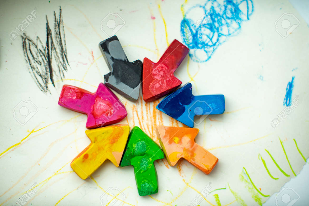 made homemade wax pencils from the wreckage of old crayons by melting them in the oven at high temperature in silicone form. crayons in the form of arrows lie on paper - 145843071 made homemade wax pencils from the wreckage of old crayons by melting them in the oven at high temperature in silicone form. crayons in the form of arrows lie on paper - 145843071