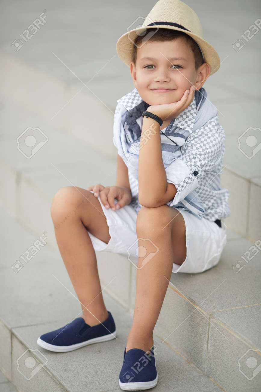 stylish baby boy having fun outside in the park cute happy boy