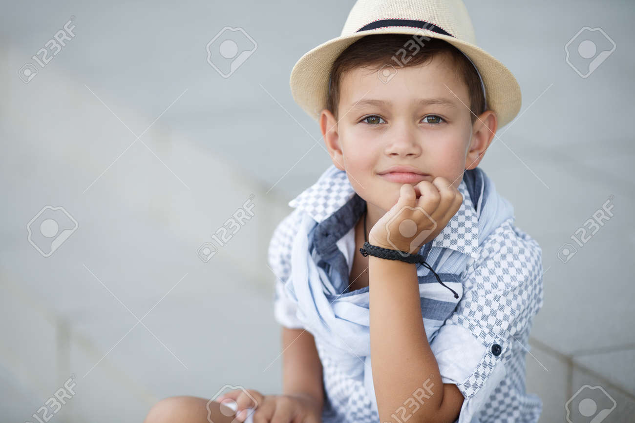stylish baby boy having fun outside in the park cute happy boy