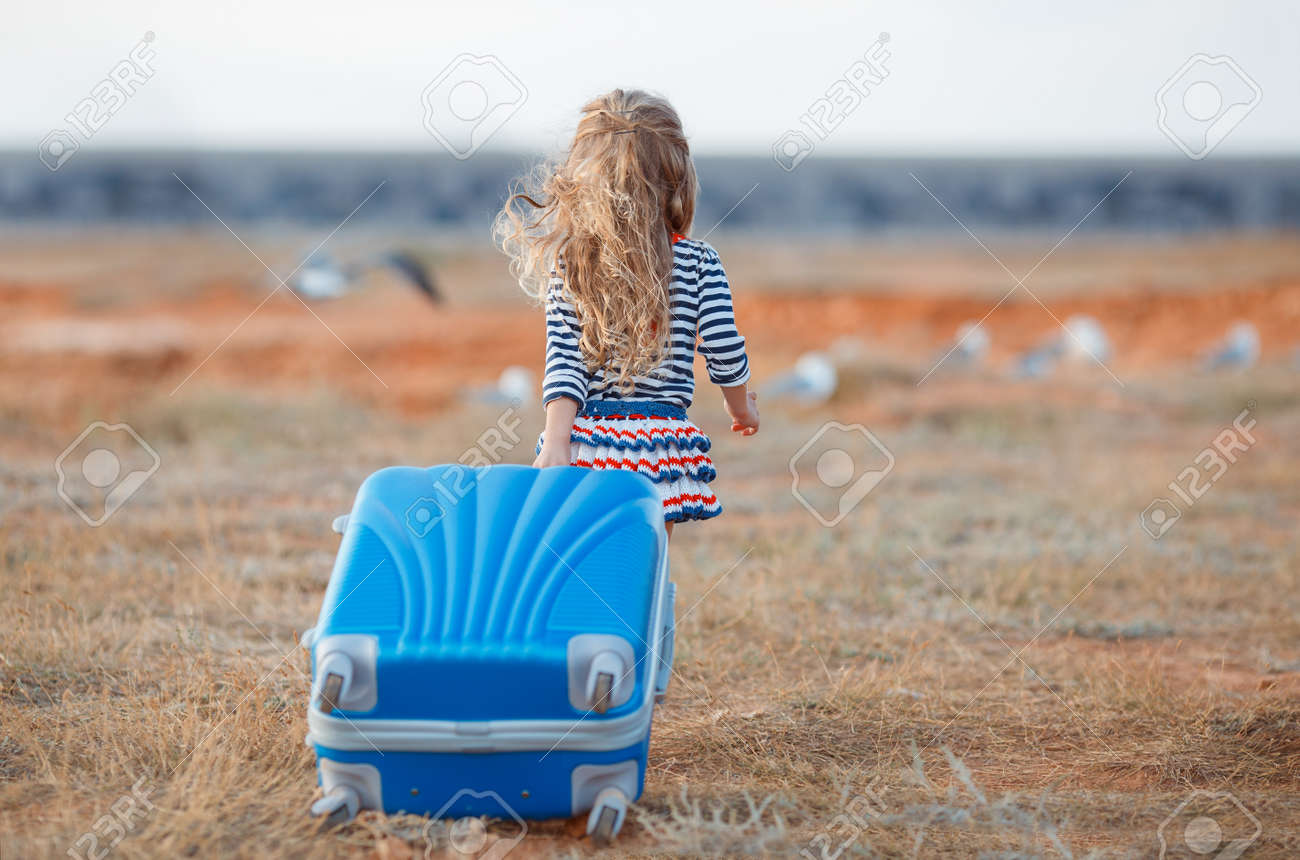 little girl with suitcase