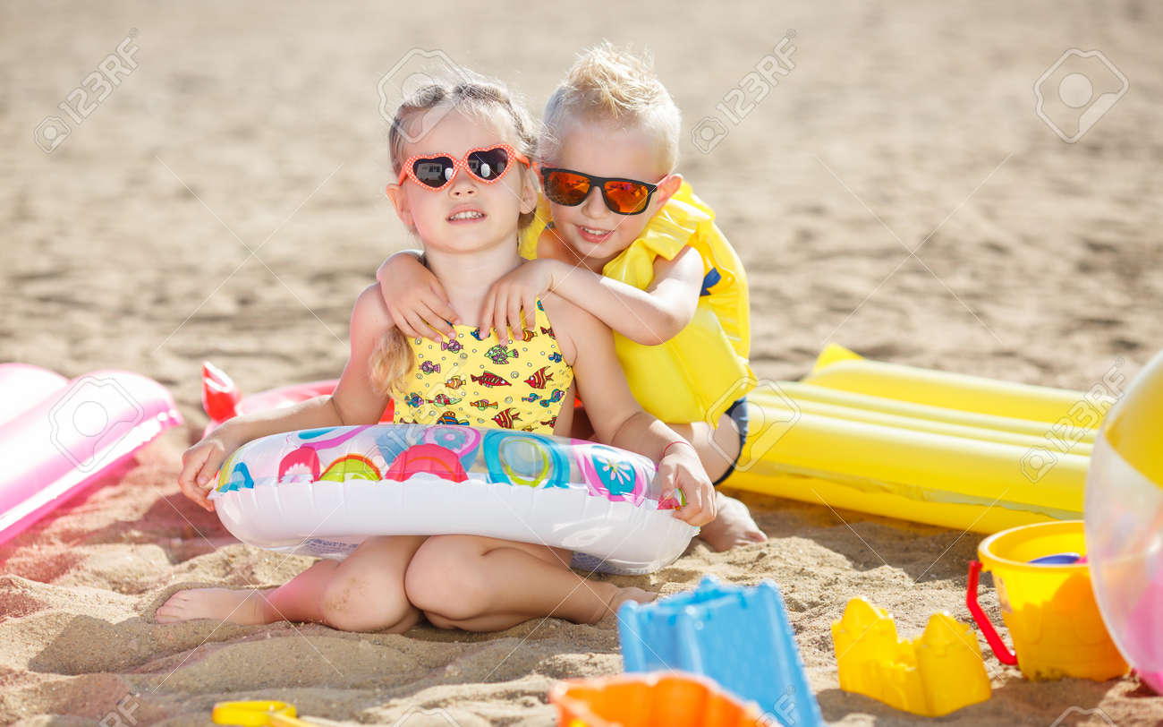 Little Girl With Pigtails And A Little Blond Boy With Short Hair