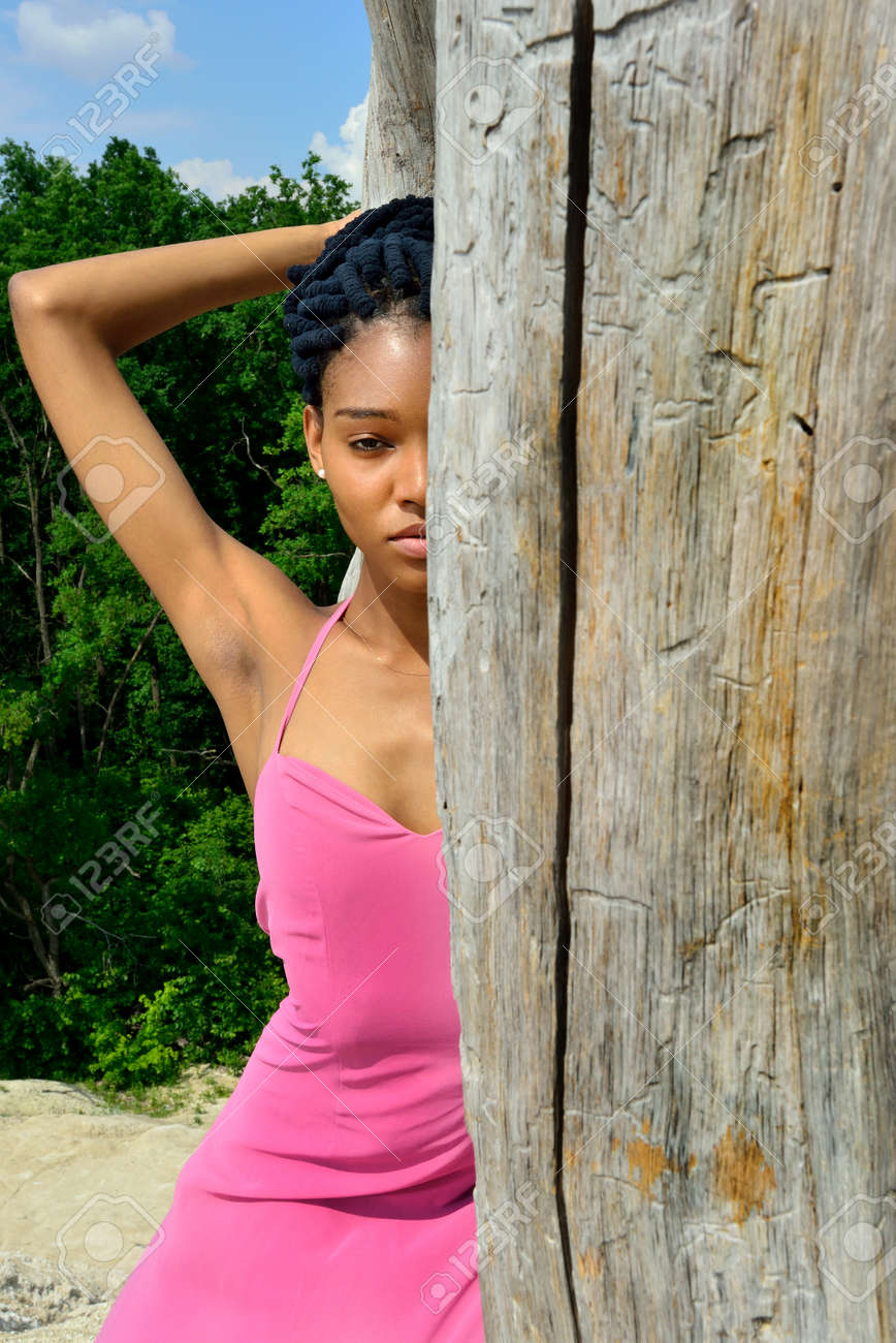 A Beautiful African American Girl With Dreads On Her Head Stands