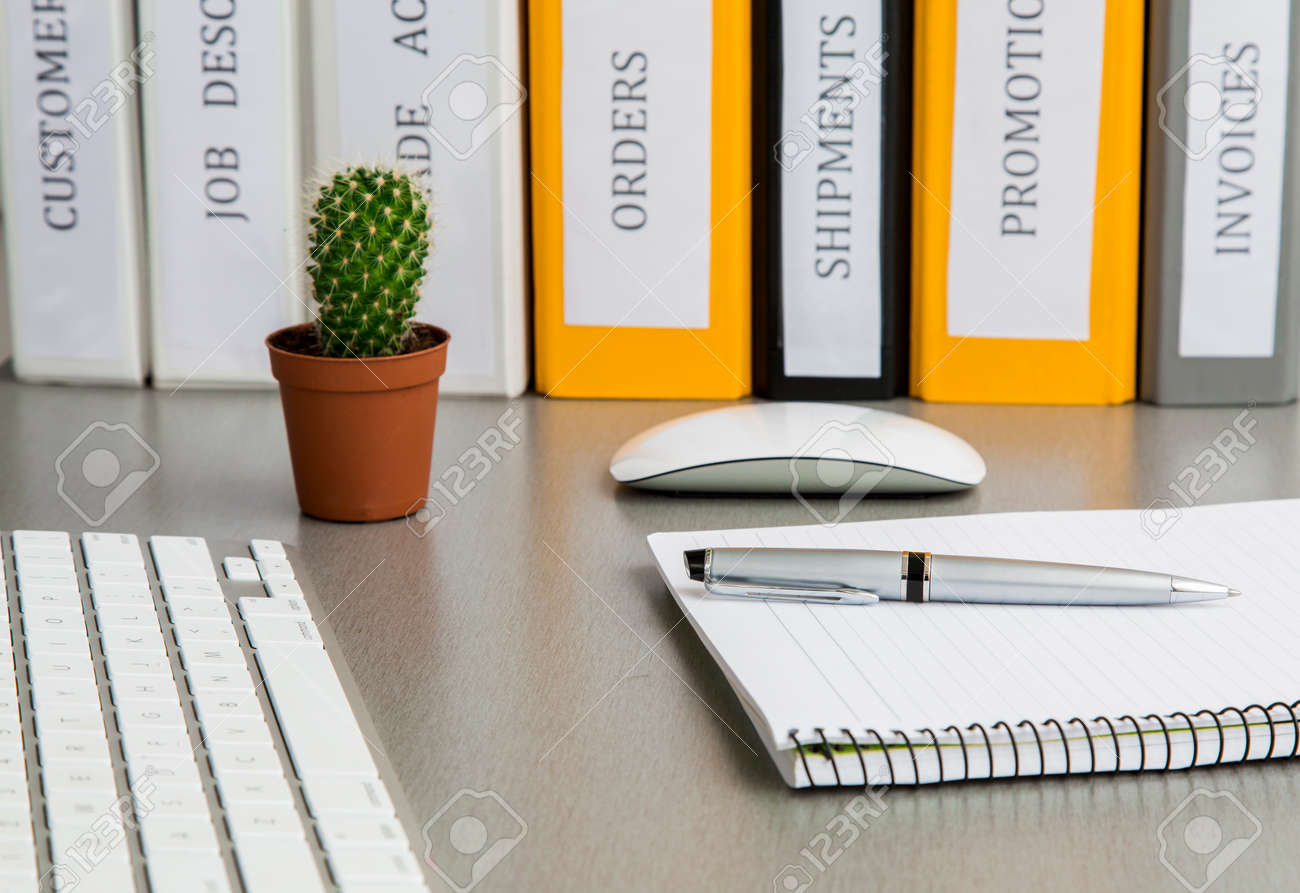 Office work space on grey desk with cactus and folders angle view on grey wooden desk with well organised office supplies coloured folders, notepad, keyboard, computer mouse and cactus - 44383910 Office work space on grey desk with cactus and folders angle view on grey wooden desk with well organised office supplies coloured folders, notepad, keyboard, computer mouse and cactus - 44383910