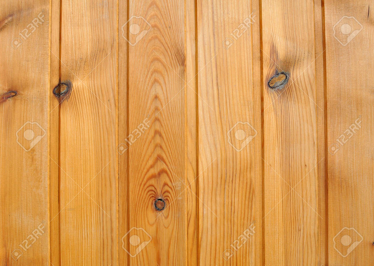 wooden wall of planed pine boards with knots stock photo picture