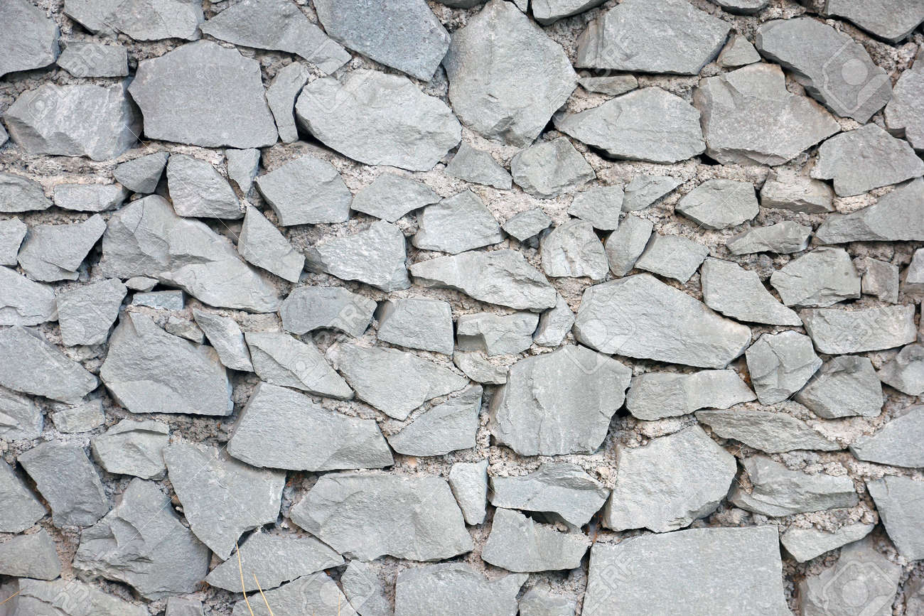 texture of old dilapidated shabby rubble stone masonry of wall stone masonry