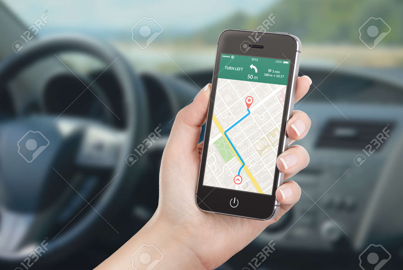 Female driver sitting in the car and holding black mobile smart phone with map gps navigation application with planned route on the screen. Blurred car interior on the background. - 32493060 Female driver sitting in the car and holding black mobile smart phone with map gps navigation application with planned route on the screen. Blurred car interior on the background. - 32493060