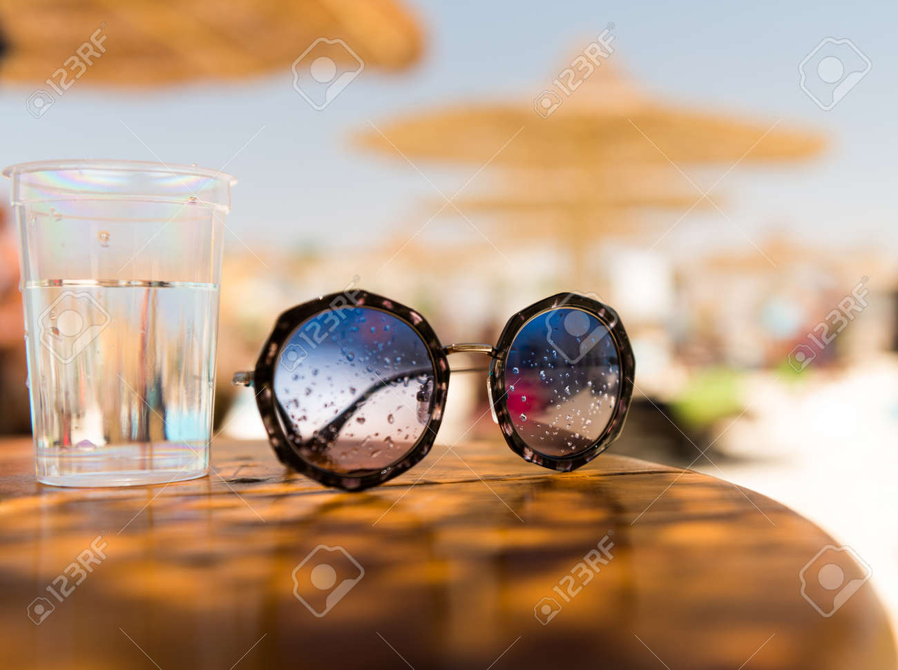 sunglasses on summer wooden table - 127951891 sunglasses on summer wooden table - 127951891