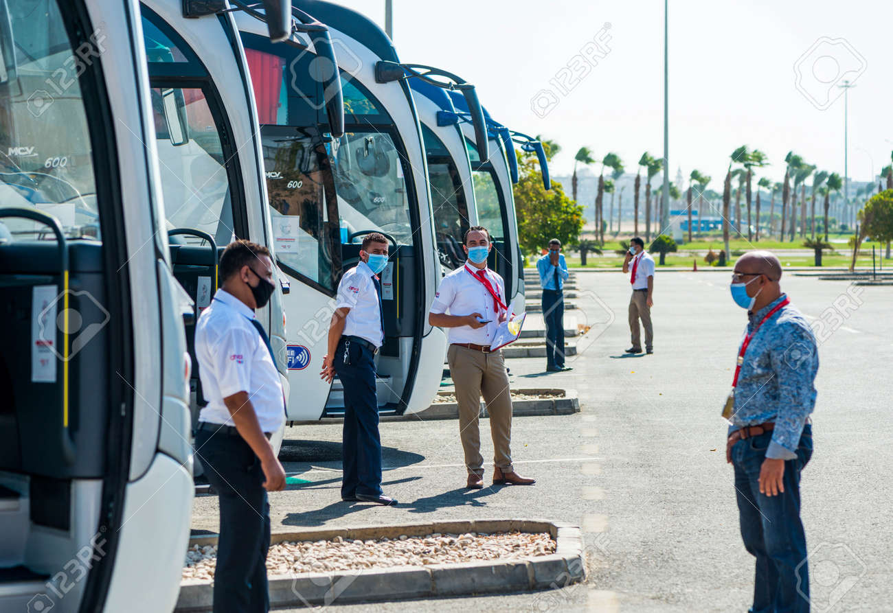 Egypt, Hurghada - 07/11/2020. tour guides in protective masks waiting for tourists at buss station near airport - 154118507 Egypt, Hurghada - 07/11/2020. tour guides in protective masks waiting for tourists at buss station near airport - 154118507