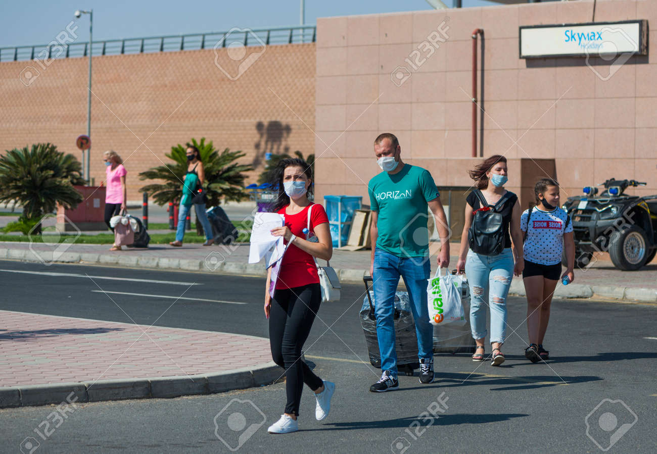 Egypt, Hurghada - 07/11/2020. tourists in protective masks after arriving leaving airport area - 154118505 Egypt, Hurghada - 07/11/2020. tourists in protective masks after arriving leaving airport area - 154118505