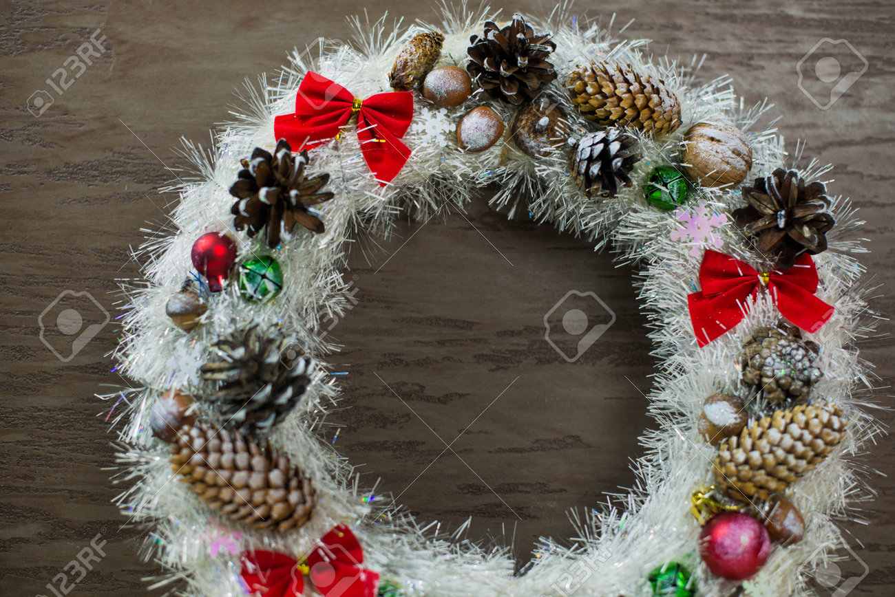 beautiful white Christmas wreath on brown wooden background - 160615634 beautiful white Christmas wreath on brown wooden background - 160615634