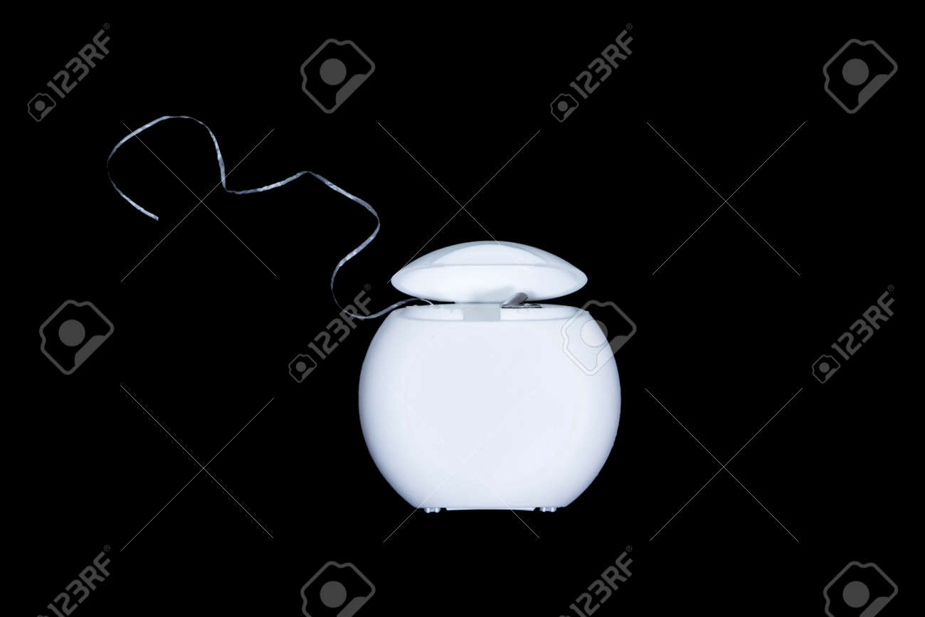 Dental floss in a white box front view, isolated on a black background - 45654754 Dental floss in a white box front view, isolated on a black background - 45654754