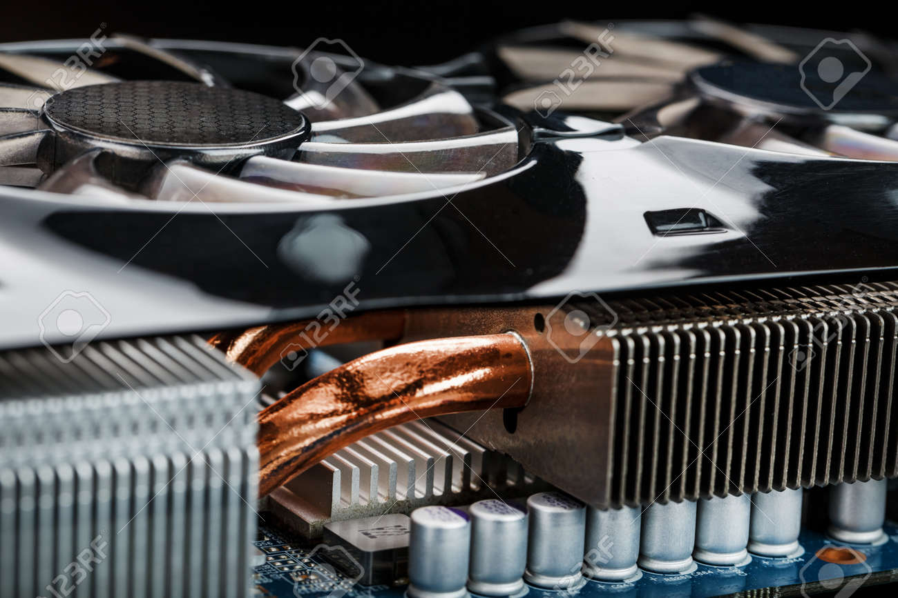 Video card with a cooling system with copper pipes, aluminum radiators and fans. Video chip for gaming and cryptocurrency mining. Dark key - 169206466 Video card with a cooling system with copper pipes, aluminum radiators and fans. Video chip for gaming and cryptocurrency mining. Dark key - 169206466
