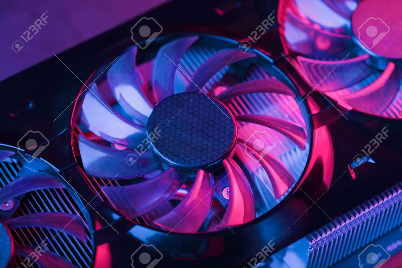 A close-up video card fan with cyanide magenta illumination in a futuristic style. Powerful gaming graphics card for video games and cryptocurrency mining. Dark Key, Close-up, Macro - 169206506 A close-up video card fan with cyanide magenta illumination in a futuristic style. Powerful gaming graphics card for video games and cryptocurrency mining. Dark Key, Close-up, Macro - 169206506
