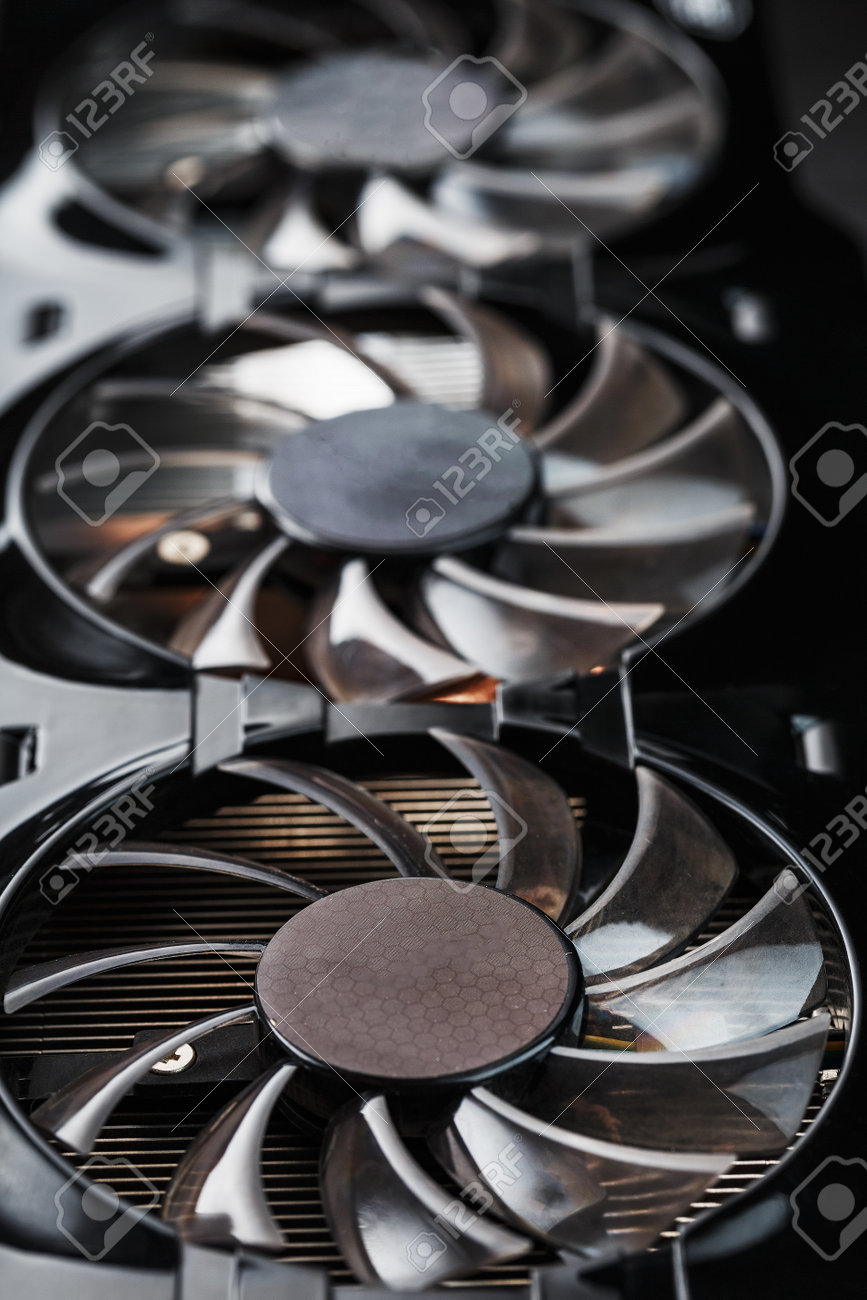 A video card with three fans is hardly a powerful cooling system. Video chip for gaming and cryptocurrency mining. Dark key - 169206510 A video card with three fans is hardly a powerful cooling system. Video chip for gaming and cryptocurrency mining. Dark key - 169206510