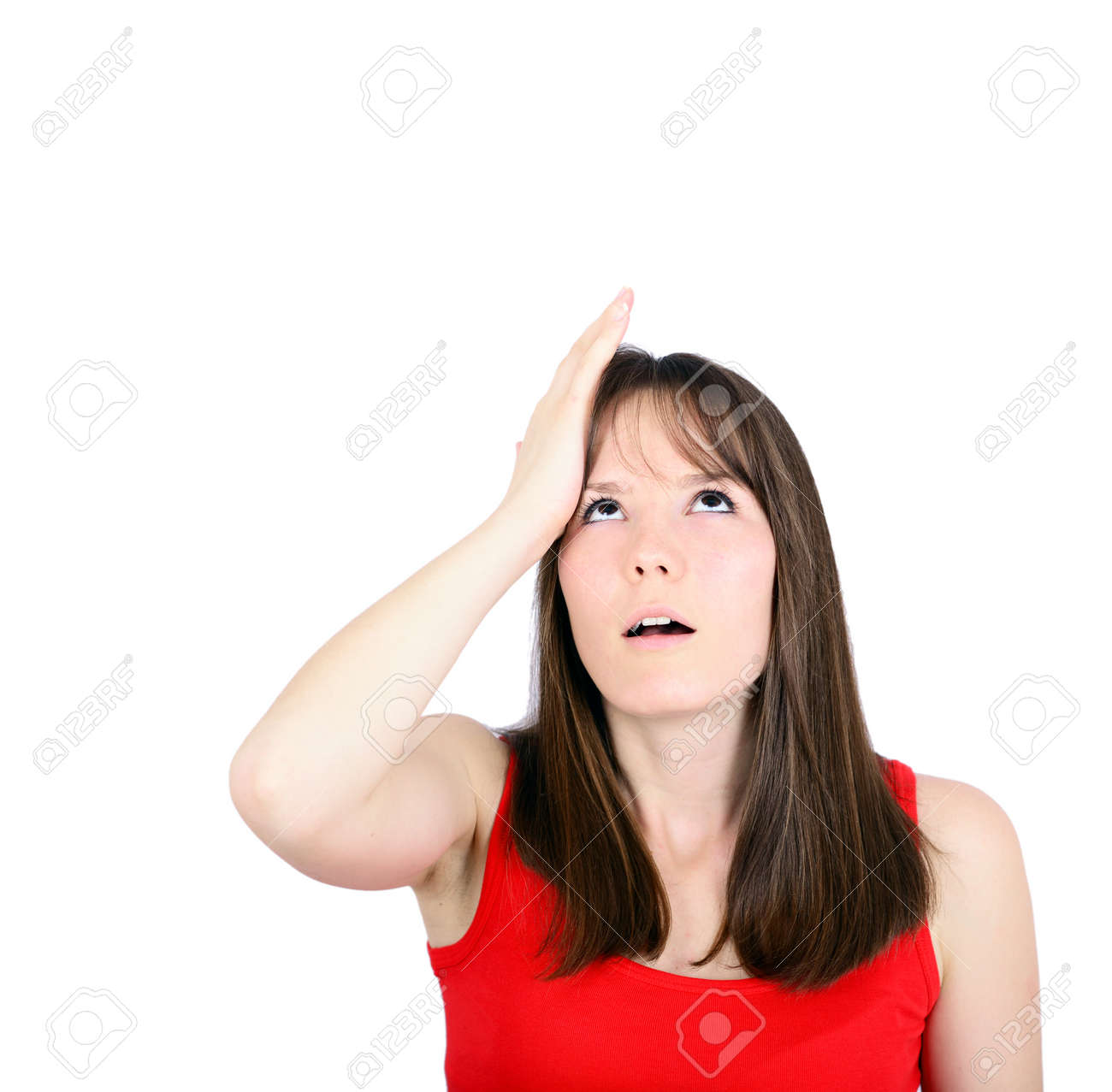 portrait of young woman slapping hand on head having a duh moment