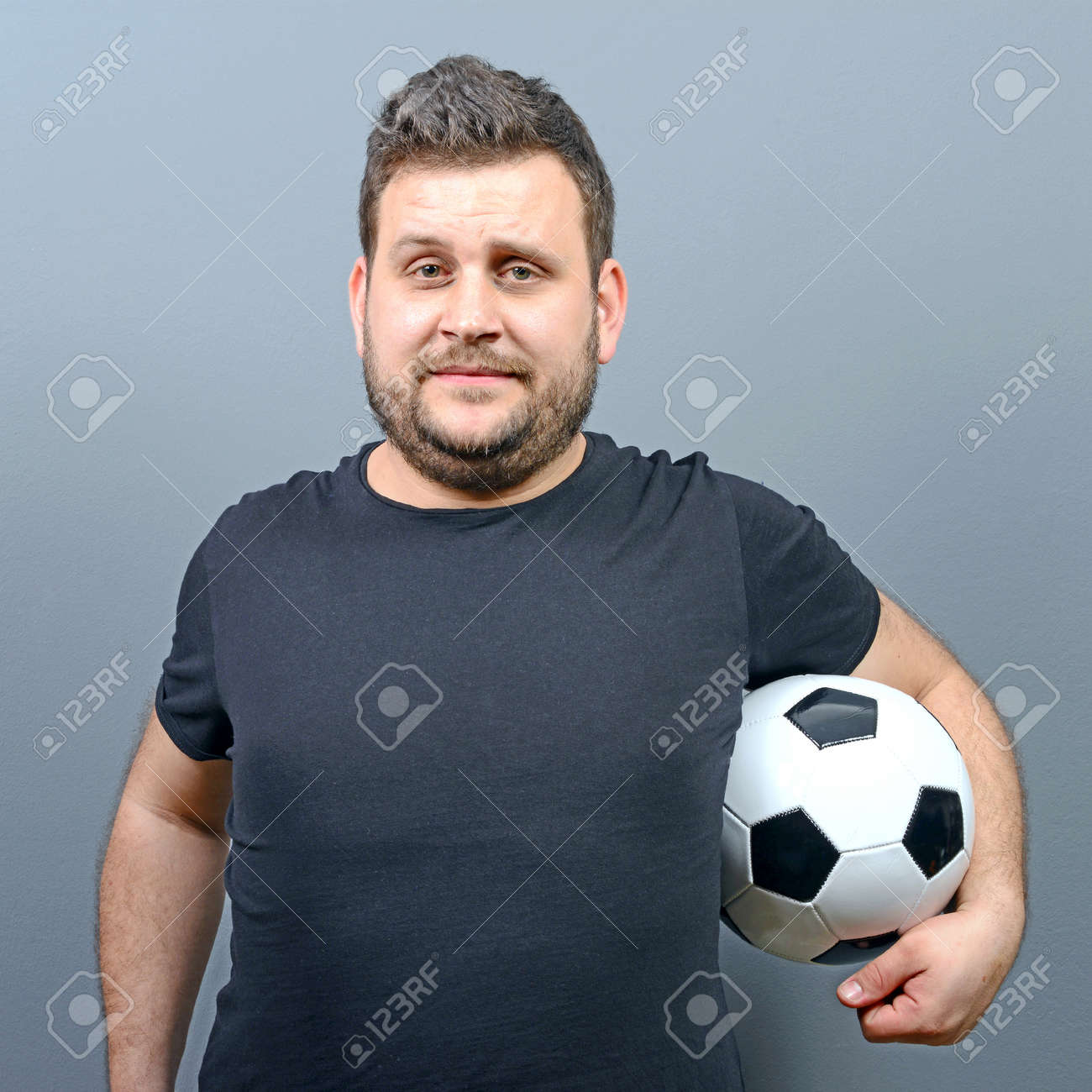 Portrait Of Chubby Man Holding Football
