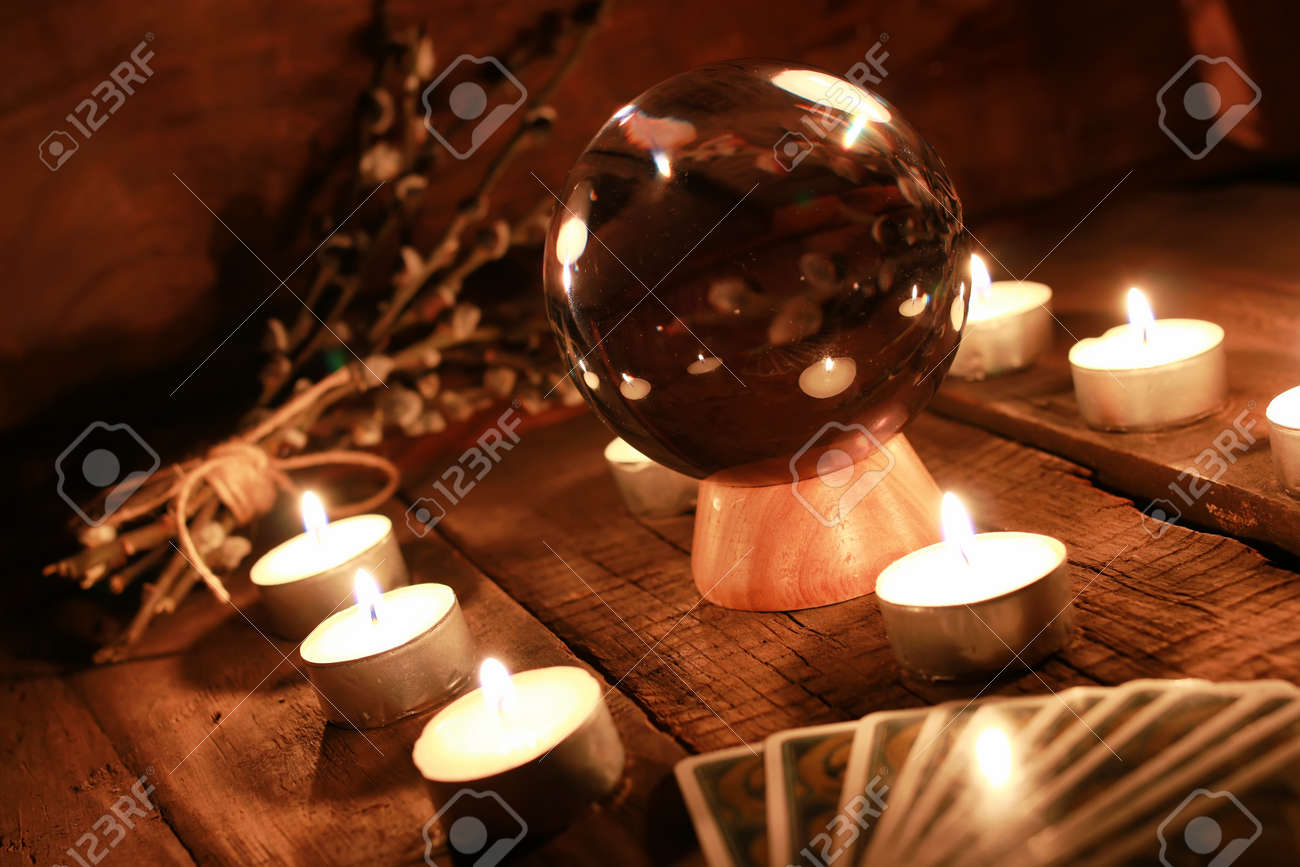 crystal ball for predicting the fate and supernatural action on the table from the old mahogany with candles and cards - 65080587 crystal ball for predicting the fate and supernatural action on the table from the old mahogany with candles and cards - 65080587