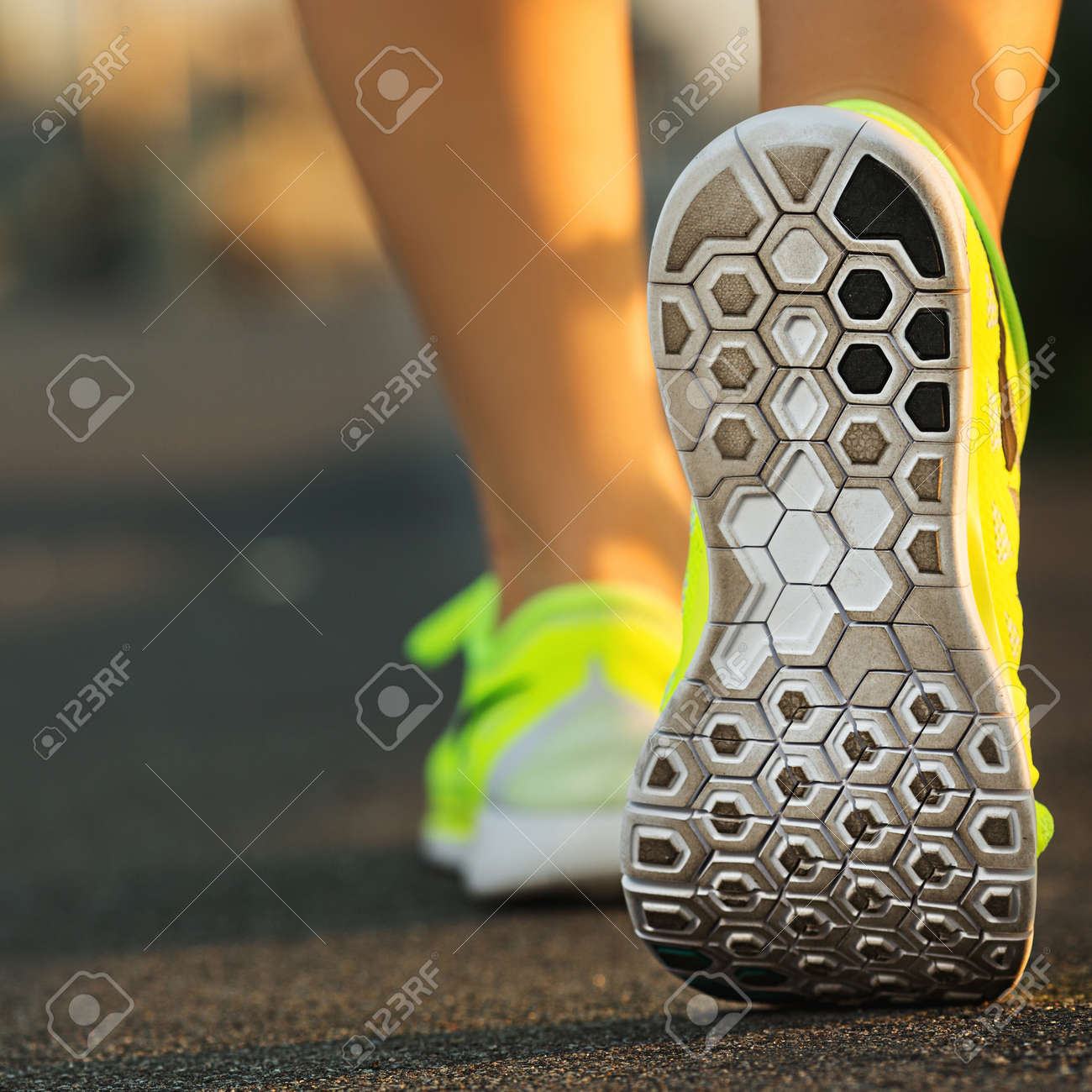 Runner woman feet running on road closeup on shoe. Female fitness model sunrise jog workout. Sports healthy lifestyle concept. - 31878070 Runner woman feet running on road closeup on shoe. Female fitness model sunrise jog workout. Sports healthy lifestyle concept. - 31878070