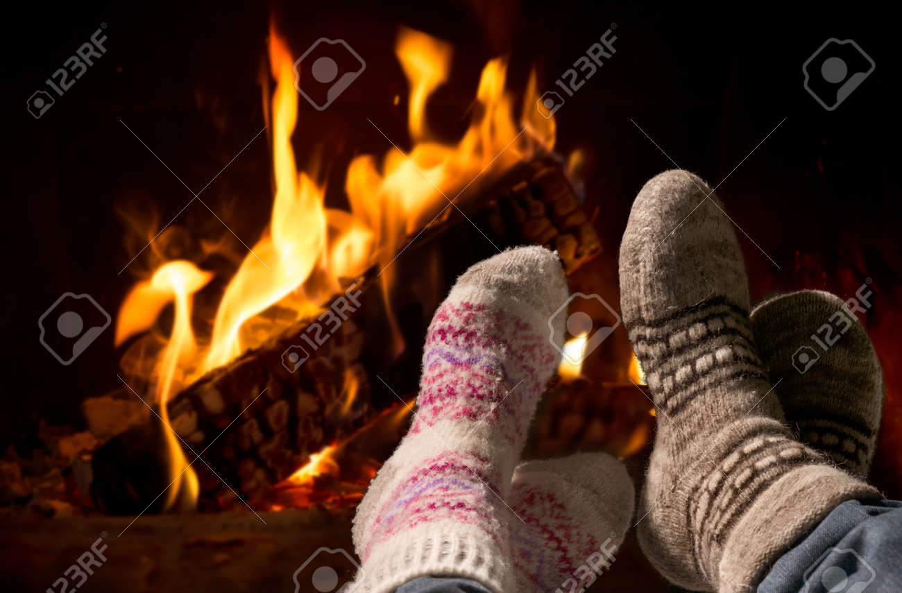 29766663-couple-relaxing-at-the-fireplace-on-winter-evening-Stock-Photo.jpg
