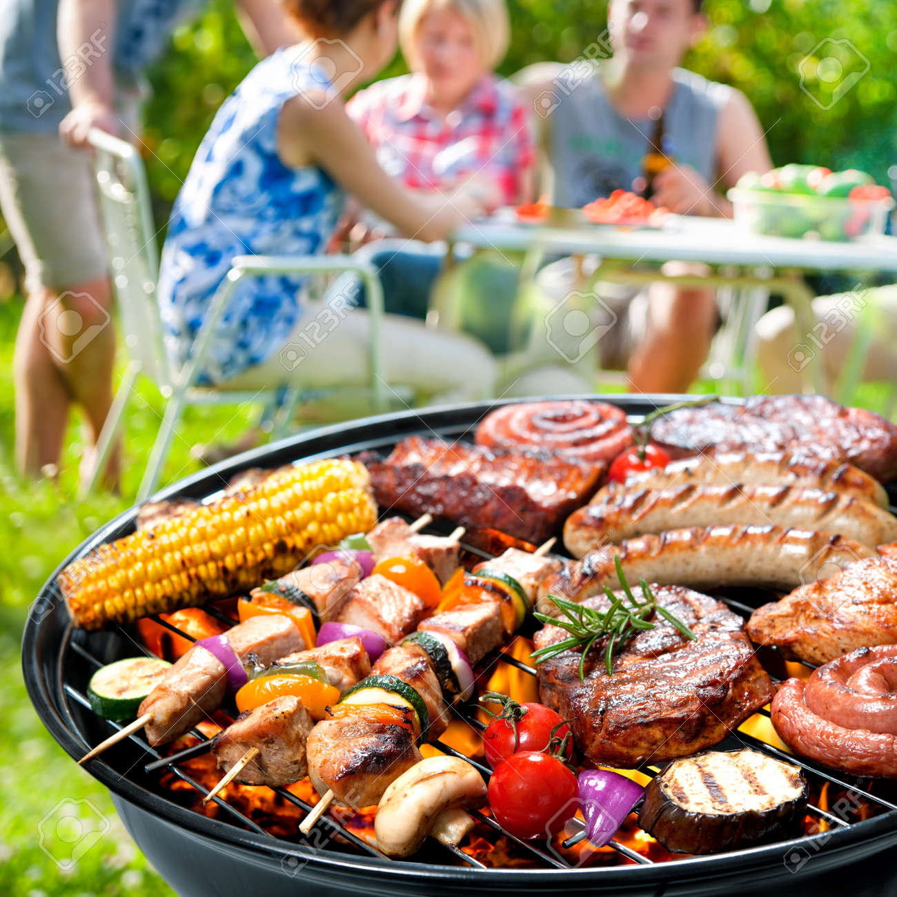 Family Having A Barbecue Party In Their Garden In Summer Stock