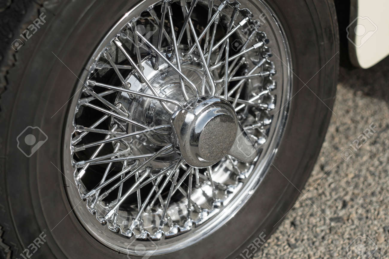 car wheel with shiny chrome rim having plenty of spokes stock photo