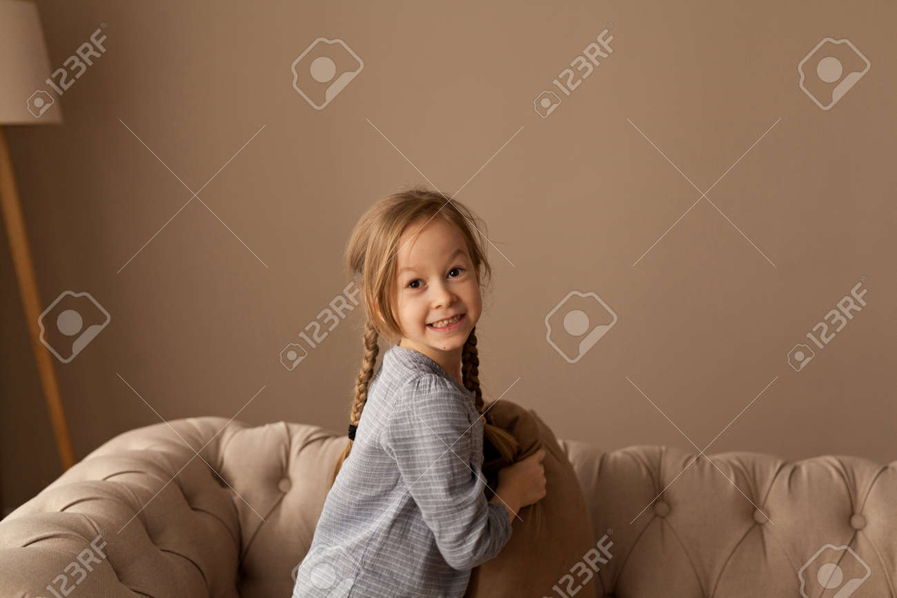 Seven year old girl plays pillow fight - 130267930 Seven year old girl plays pillow fight - 130267930
