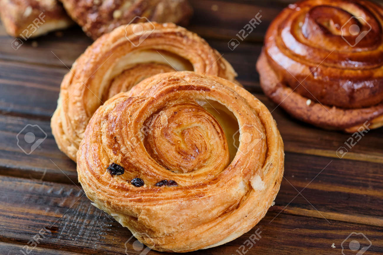 buns with berry jam on a dark wooden background. Rustic style. Close-up. Selective focus - 131563560 buns with berry jam on a dark wooden background. Rustic style. Close-up. Selective focus - 131563560
