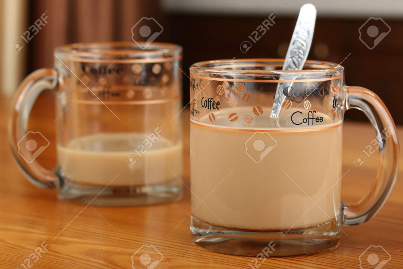 Half Empty And Full Transparent Glass Cup With Coffee And Milk On A Wooden Table Stock Photo Picture And Royalty Free Image Image
