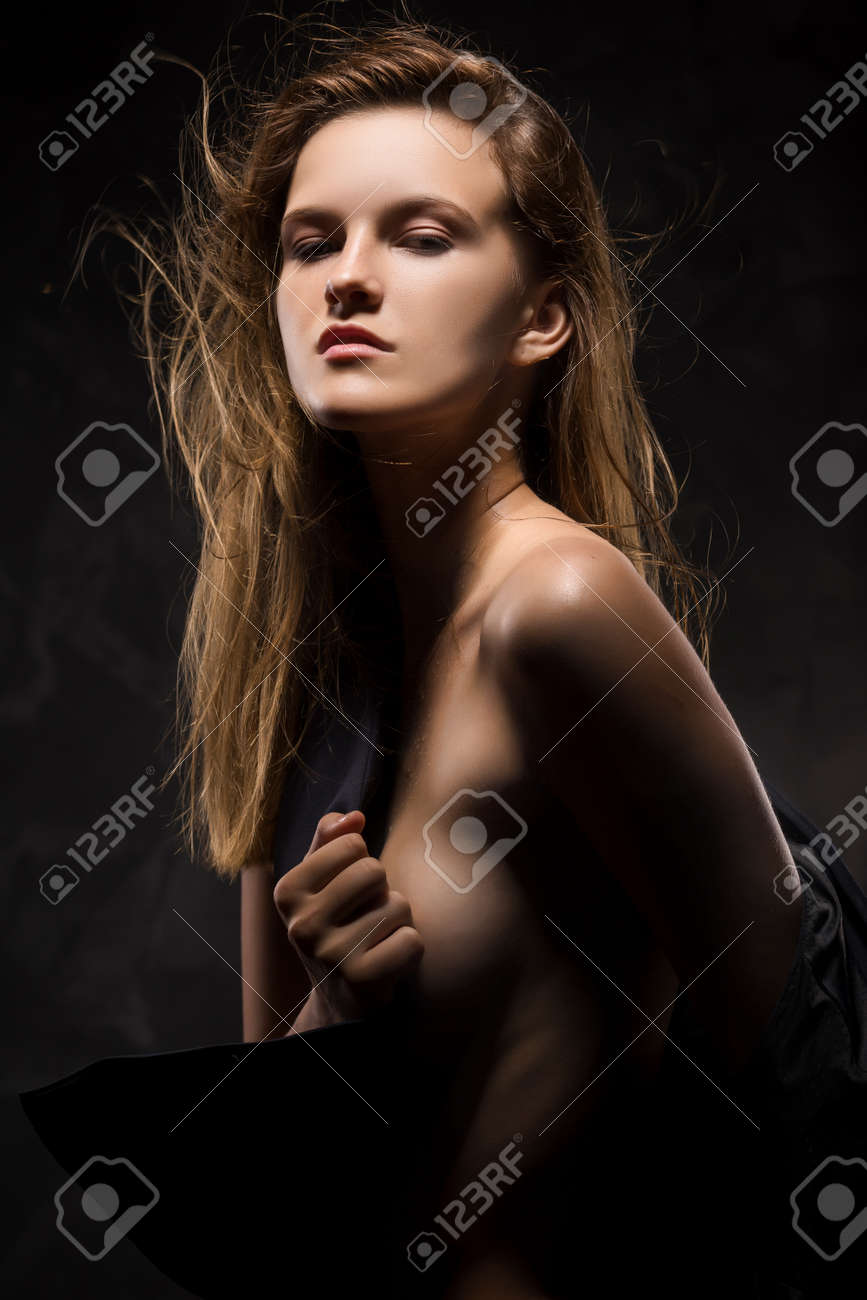 The Naked Sensual Girl Covering Her Breast By A Vest. Hair Fluttering On  Wind. Copy Space. Wet Skin Stock Photo, Picture and Royalty Free Image.  Image 88556310.