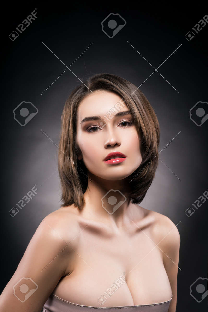 Beautiful Mixed Asian-caucasian Race Girl. Advertising And Commercial  Design. Shopping. Big Breast. Gray-black Background. Red Lips. Healthy  Clean Skin. Stock Photo, Picture and Royalty Free Image. Image 93269231.