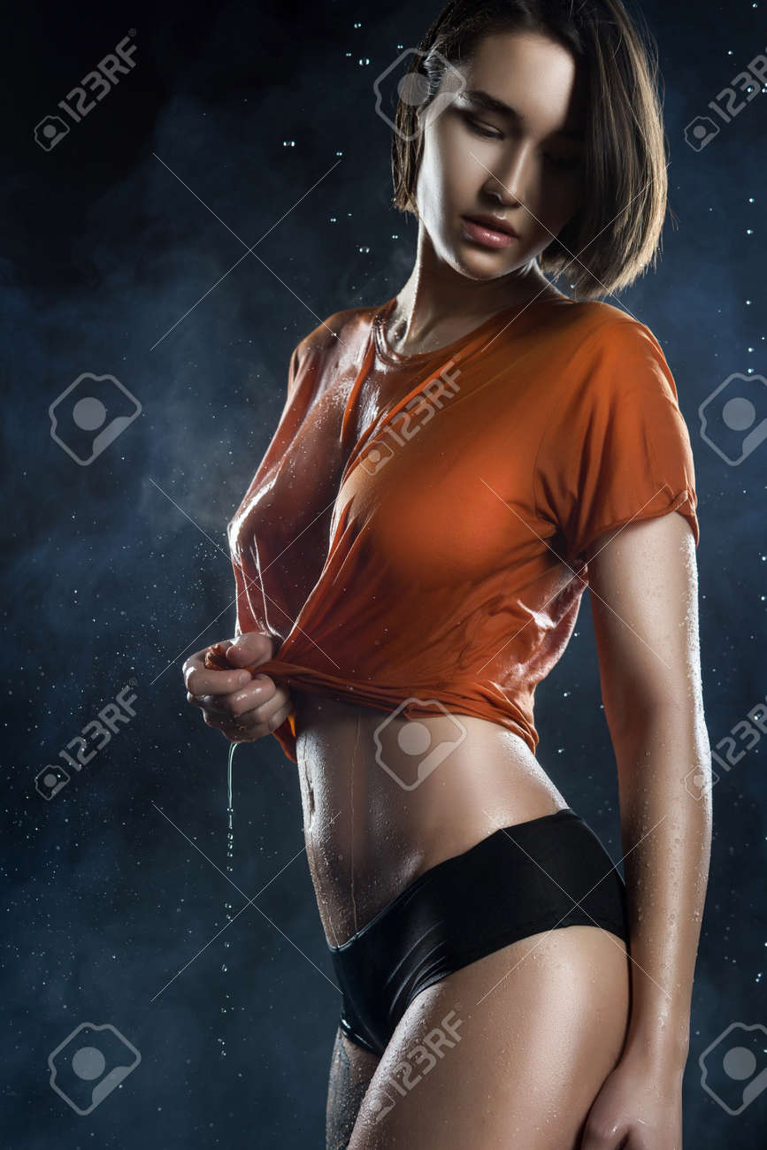 Beautyful Big Breasted Girl Wearing Wet Shirt On A Dark Background Stock Photo Picture And Royalty Free Image Image 96130914
