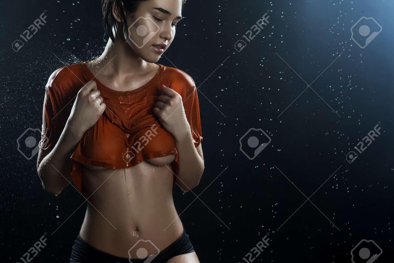 Beautyful Big Breasted Girl Wearing Wet Shirt On A Dark Background Stock Photo Picture And Royalty Free Image Image 96143331