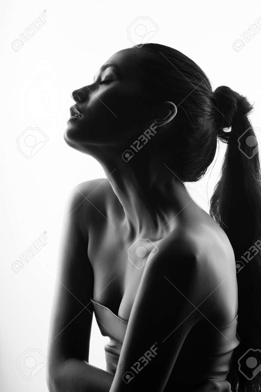Close up portrait of a brunette girl with nude make up and naked