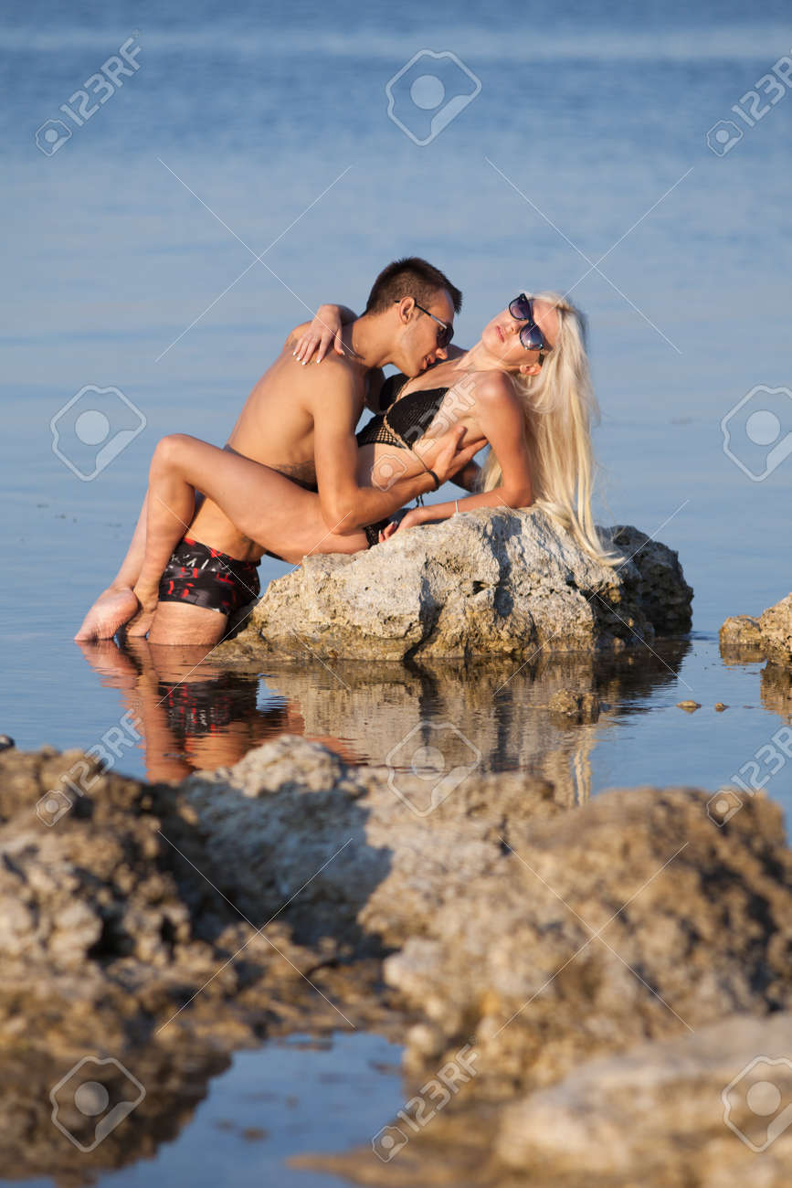 妻　セクシー　海 魅力的なカップル海若い男といちゃつく、海で野生の岩の上にキス、水着の女性の写真素材・画像素材 Image 13764069