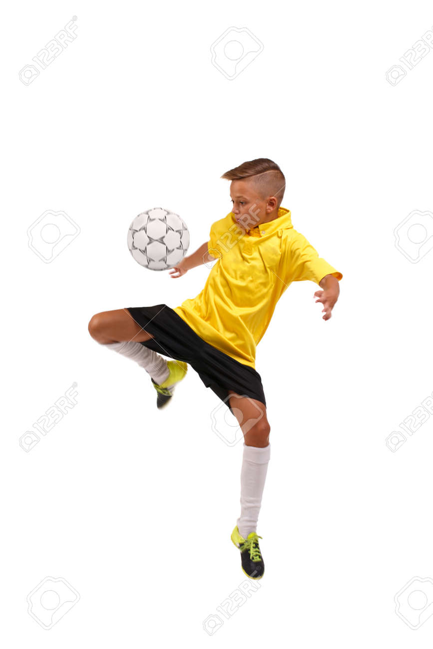 a sportive boy kicking a soccer ball a little kid in a football