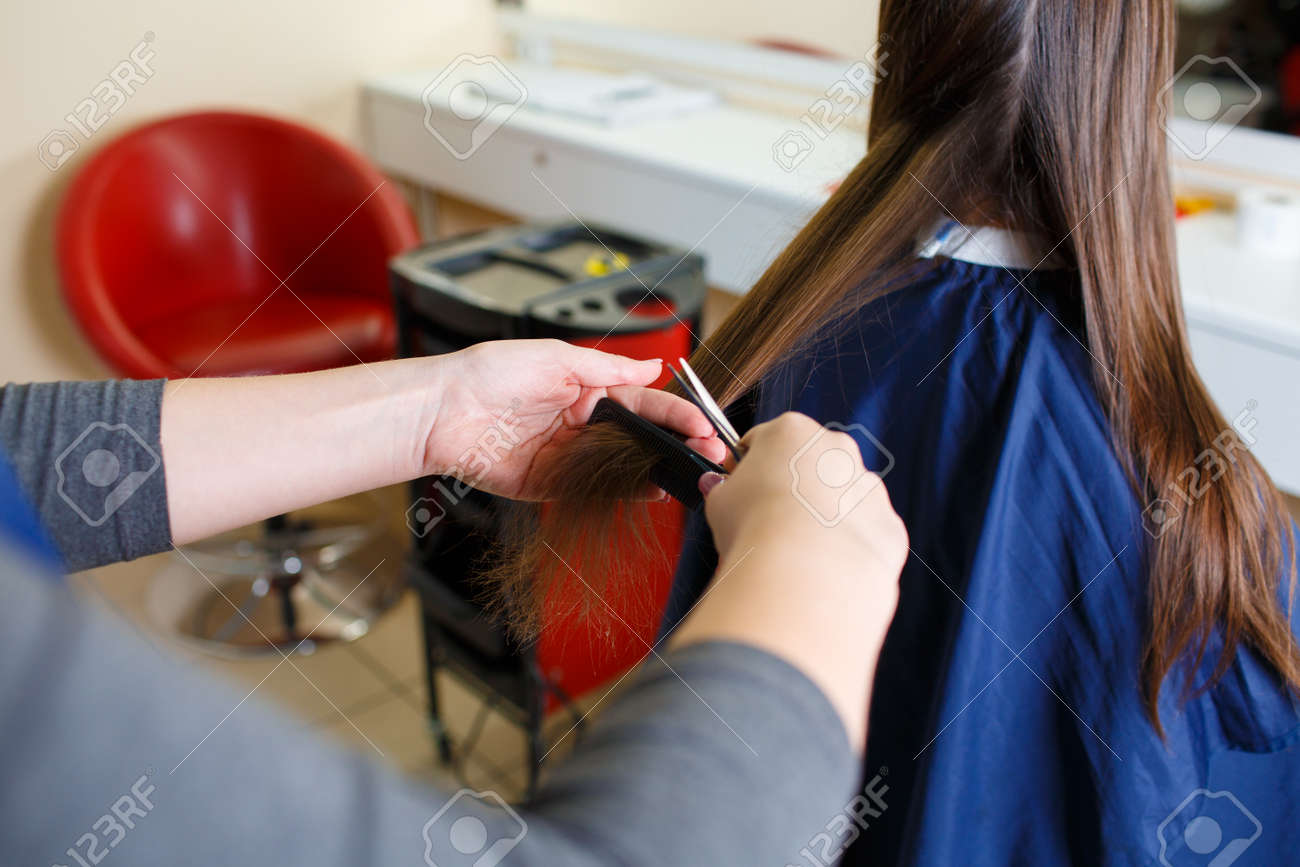 Close Up Barber Woman Styling Long Hair On A Shop Background