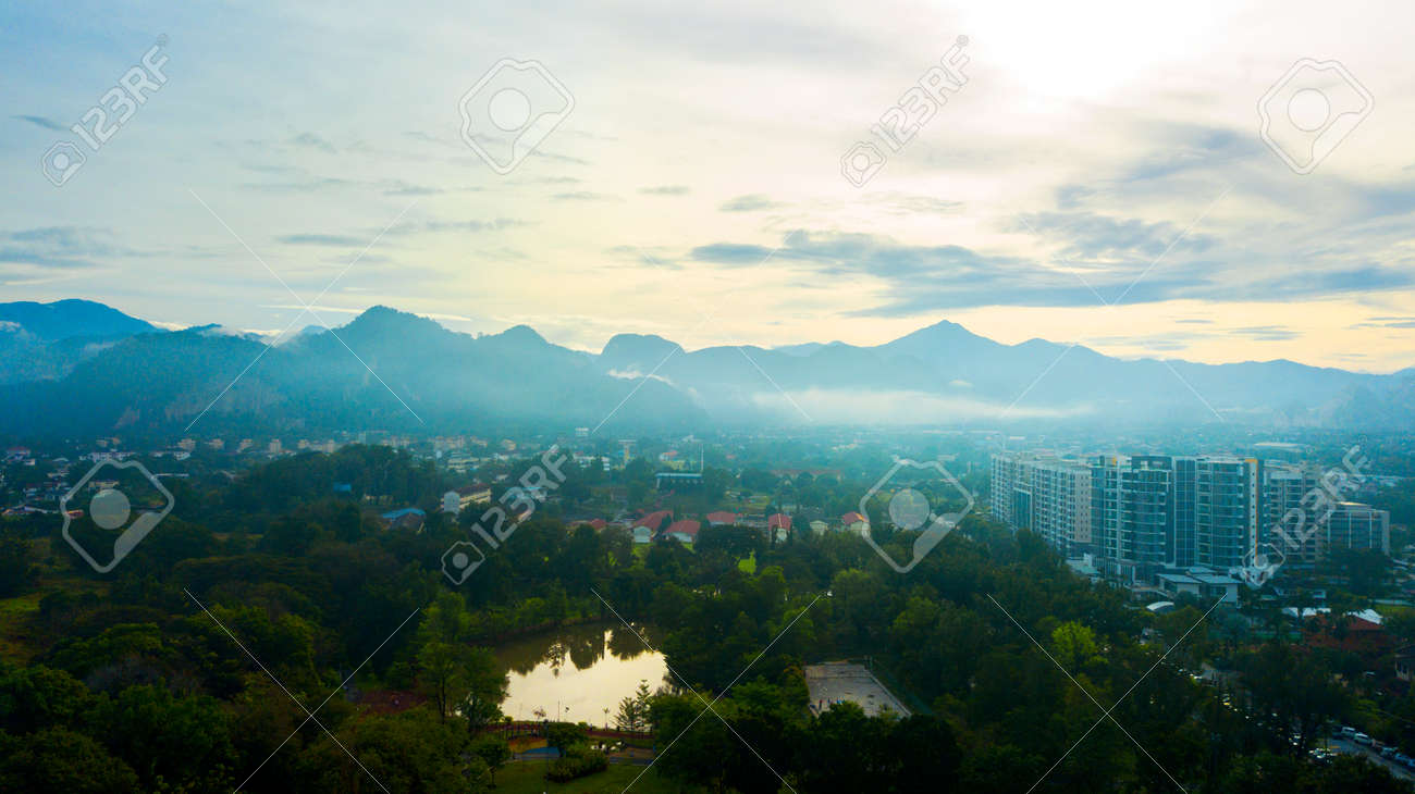 Aerial photography of a mist covered mountain in Ipoh from a public recreational park during sunrise. - 123744387 Aerial photography of a mist covered mountain in Ipoh from a public recreational park during sunrise. - 123744387