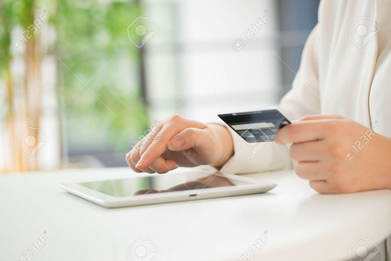 Hands of an office woman typing keyboard with credit card - 43143853 Hands of an office woman typing keyboard with credit card - 43143853