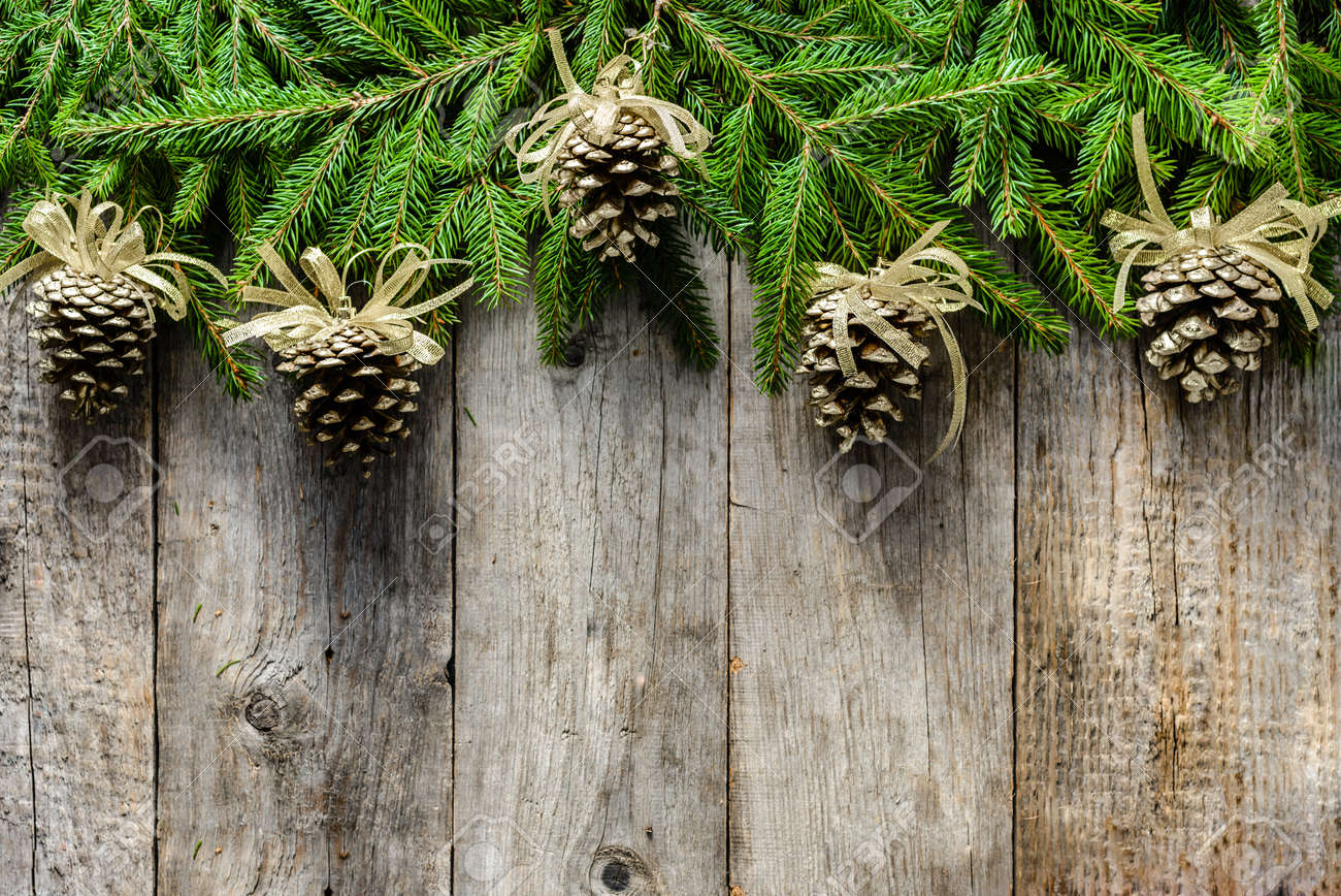 wooden background with christmas decoration golden pine cones