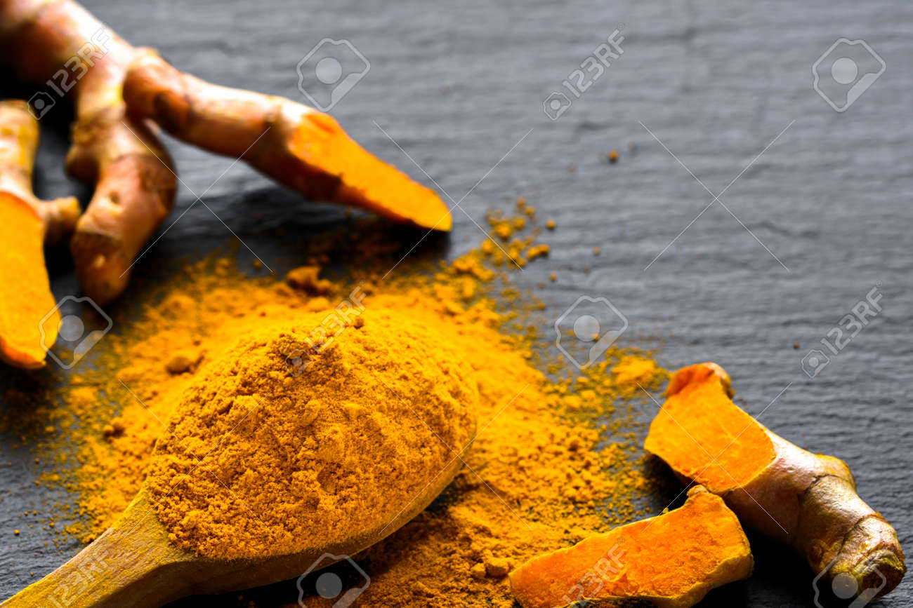Fresh root and turmeric powder, indian spice, healthy seasoning ingredient for vegan cuisine - 100639359 Fresh root and turmeric powder, indian spice, healthy seasoning ingredient for vegan cuisine - 100639359