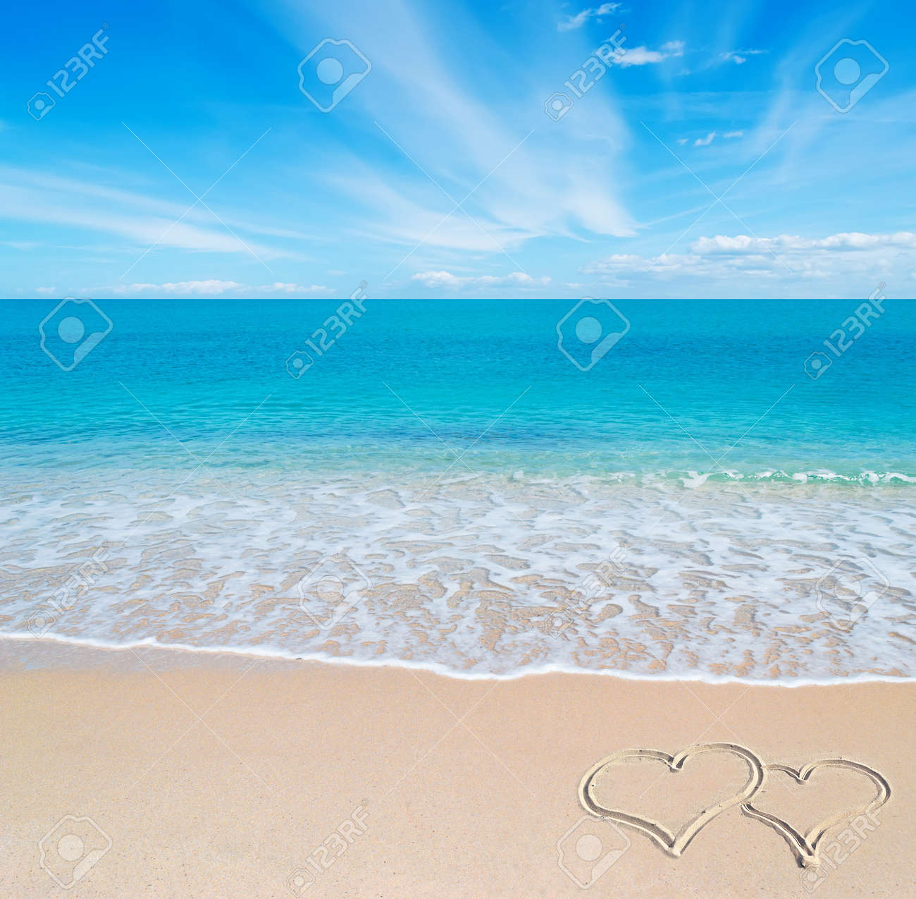 turquoise water and golden sand in Sardinia with two hearts drawn in the sand on a cloudy day - 18916983 turquoise water and golden sand in Sardinia with two hearts drawn in the sand on a cloudy day - 18916983