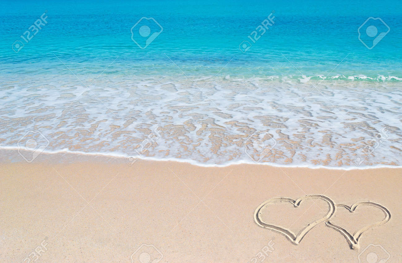 turquoise water and golden sand in Sardinia with two hearts drawn in the sand - 18917023 turquoise water and golden sand in Sardinia with two hearts drawn in the sand - 18917023