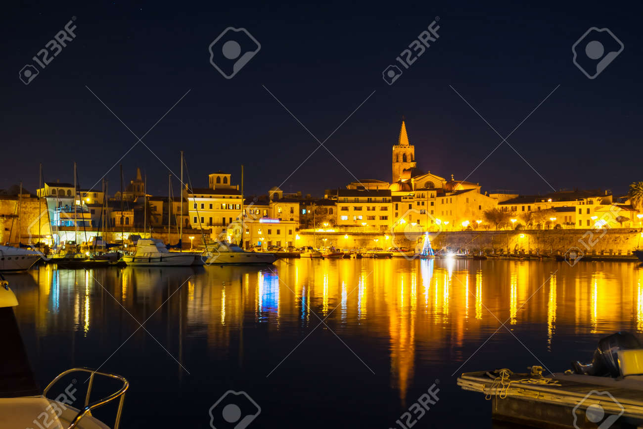 Alghero cityscape under a clear sky at night, Italy - 55874246 Alghero cityscape under a clear sky at night, Italy - 55874246