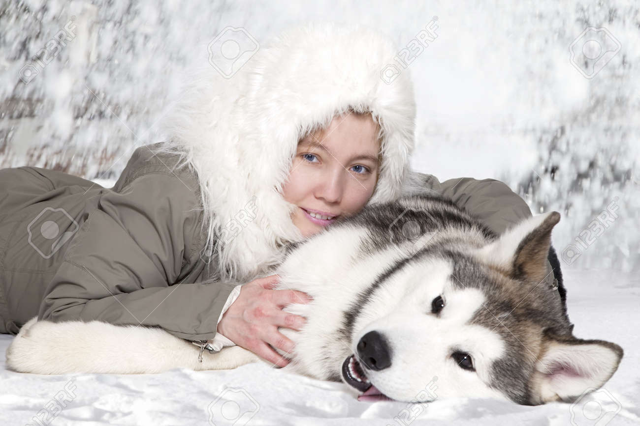 Five month old malamute puppy with young caucasian woman - 13048021 Five month old malamute puppy with young caucasian woman - 13048021