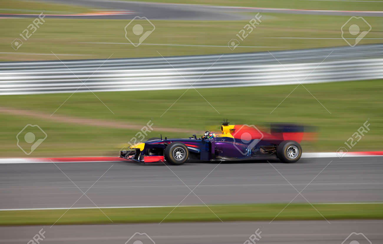 Formula 1.0 race car racing at high speed with motion blur on a racing track - 92845807 Formula 1.0 race car racing at high speed with motion blur on a racing track - 92845807